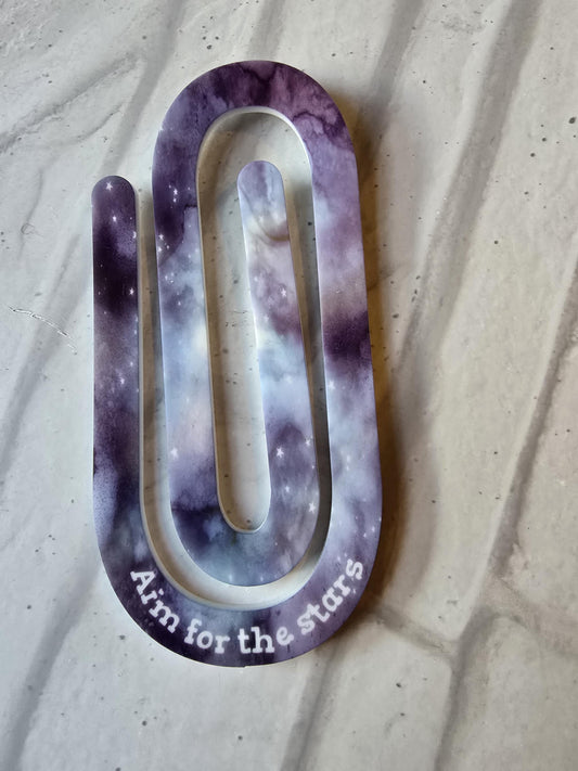 Giant paper clip with Aim for the stars wording
